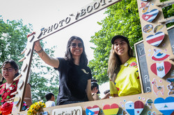 Photo: Two women stand at an international stand at TU Dortmund University's summer festival and smile at the camera..