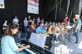 Several musicians play instruments on stage