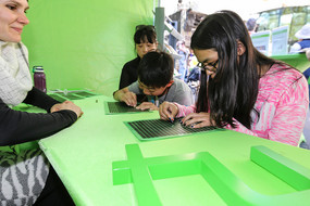 Girl and boy solve a puzzle at the table with free scratch fields.