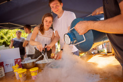 Summer festival 2022 Three people make frozen yogurt at a table.