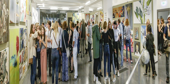 people are running through an exhibition.
